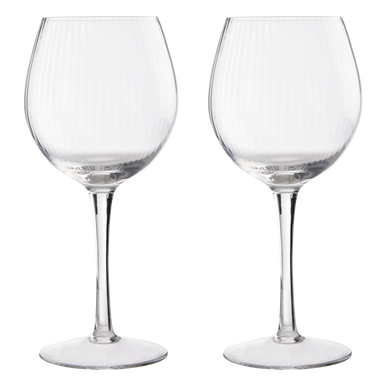 A pair of clear mila set gin glasses with slender stems and fluted texture perfect for cocktails