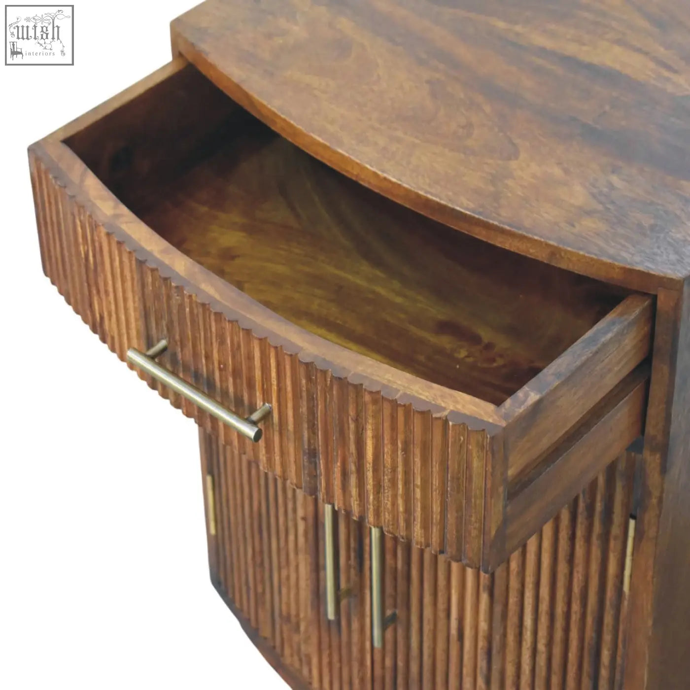 A rustic wooden milan fluted bedside cabinet with curved top ribbed grooves and brass handles