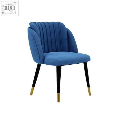 A stylish navy blue milano velvet dining chair with a fluted back and black legs with gold tips perfect for dining room