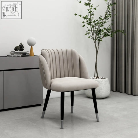 Beige milano velvet dining chair with vertical pleats and black legs capped in silver for stylish dining seating
