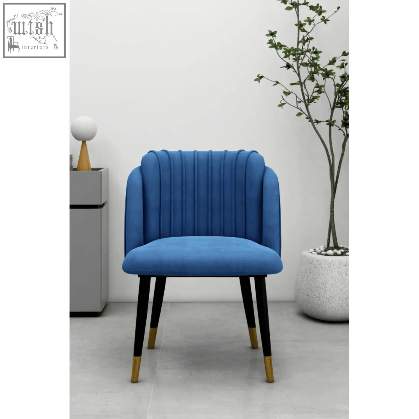 A vibrant blue milano velvet dining chair with tufted back and black legs accented with gold feet