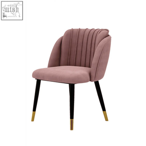 A plush rose pink milano velvet dining chair with scalloped back and black legs with gold tips perfect for dining room