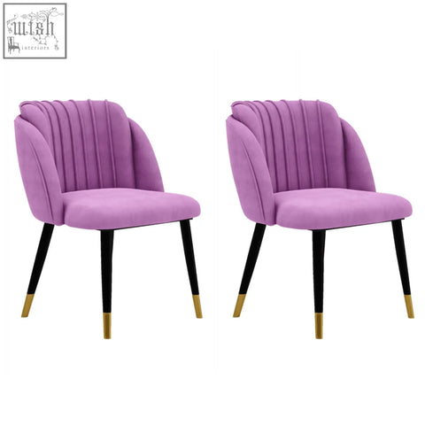 Pair of milano velvet dining chairs in purple velvet with black legs and gold-tipped feet perfect for dining rooms