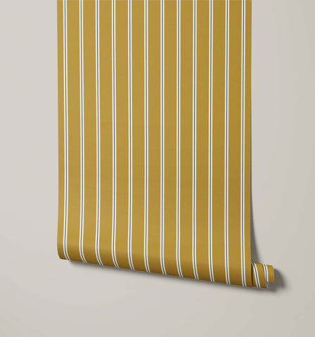 A roll of miller mustard yellow pinstripe wallpaper with thin white vertical stripes perfect for walls