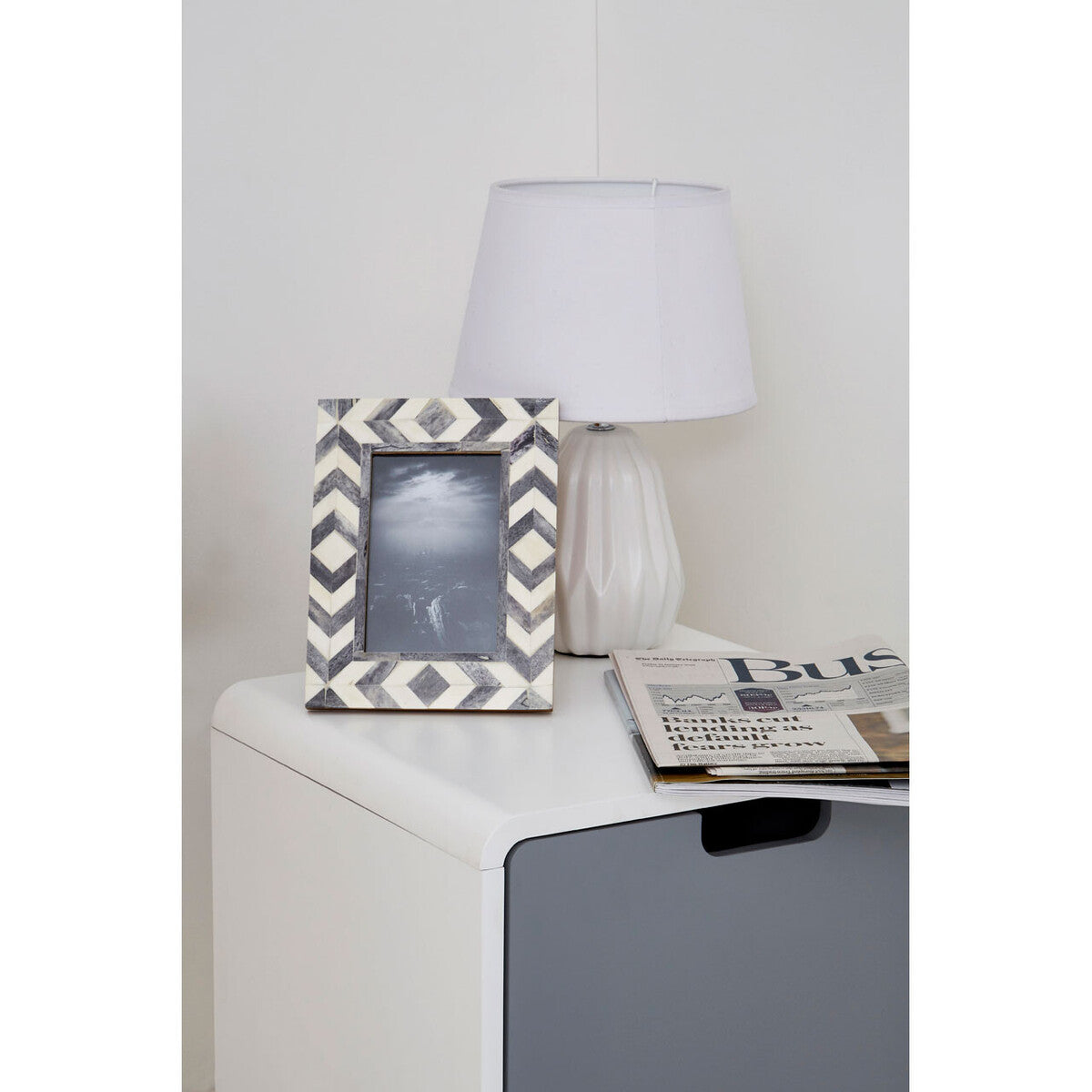 Milo 1 door cabinet with black and white chevron-patterned frame and diamond inset on natural legs light two-tone design