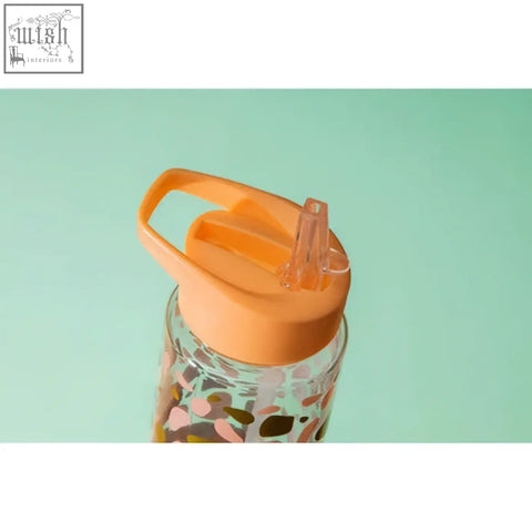 Orange silicone lid with clear straw on mimo animal print water bottle featuring colorful abstract animal print design