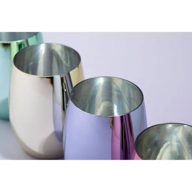 A sleek metallic stemless wine glass from mimo set with a reflective silver interior and iridescent assorted colours tumblers exterior