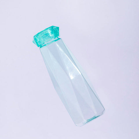 A translucent teal mimo teal drinking bottle with a faceted gemstone-like cap for stylish hydration