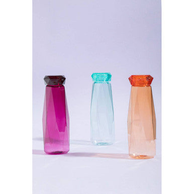 Three translucent faceted water bottles with gemstone-inspired caps featuring mimo teal drinking bottle in vibrant hues