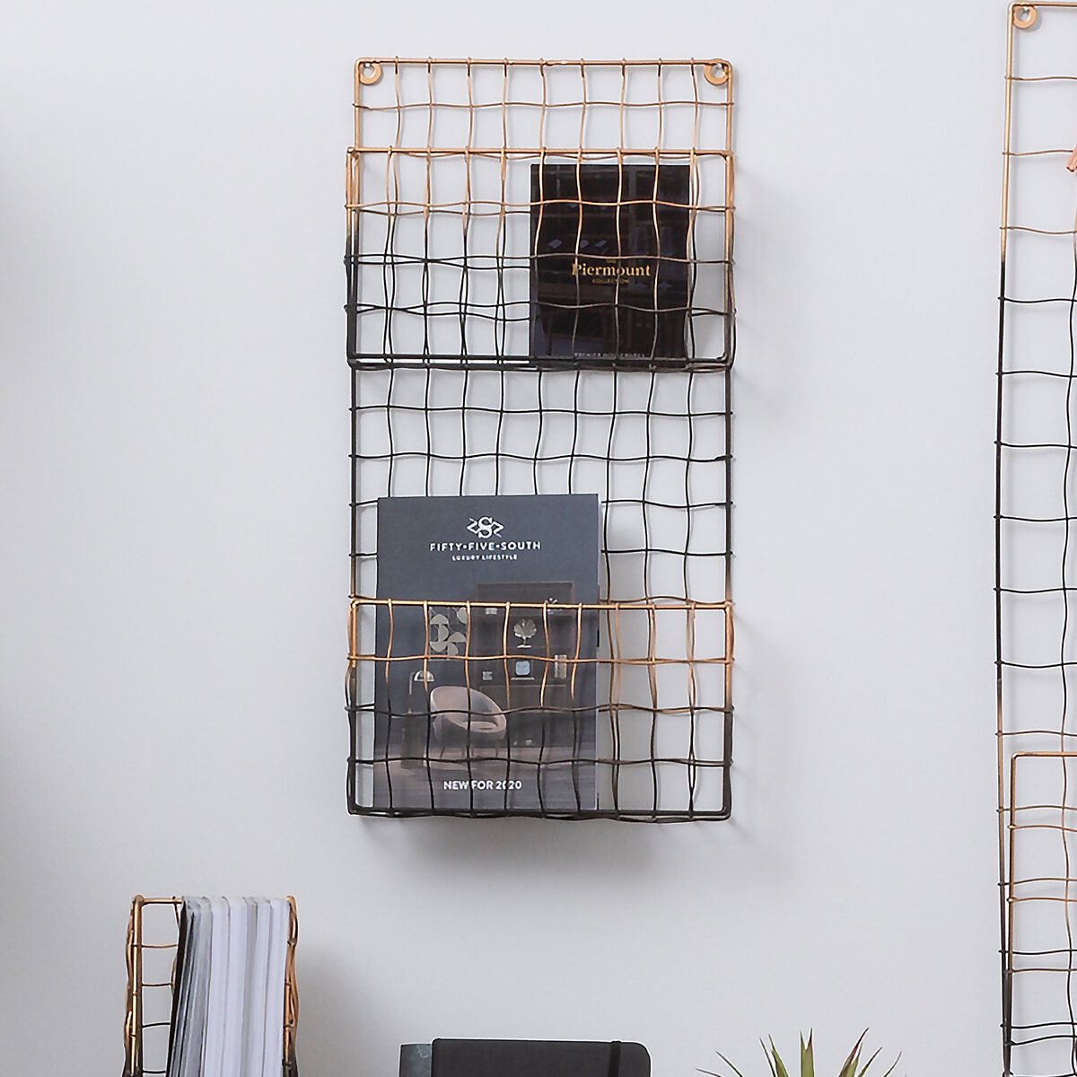 Mimo wall mount magazine rack with two-tiered black and copper metal mesh design for stylish wall storage