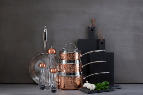 Stacked Minerva copper finish large hammered saucepans with stainless steel rims and lids in copper finish large design