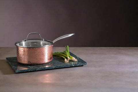 A hammered copper finish large 20 cm saucepan with stainless steel lid and handle in a sleek reflective finish