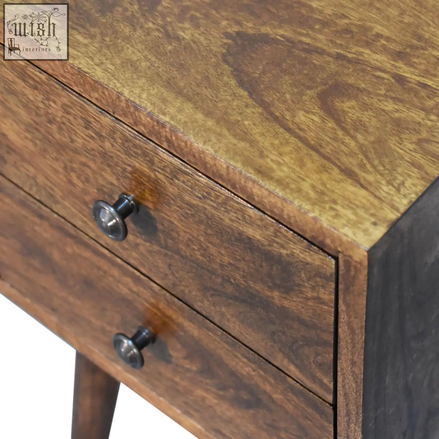 A rustic mini 2-drawer chestnut bedside table with round black metal knobs and wooden finish perfect for small spaces