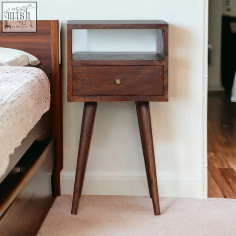 Mini cherry bedside table in dark wood with glass front, single drawer with brass knob, and tapered legs, solid mango wood