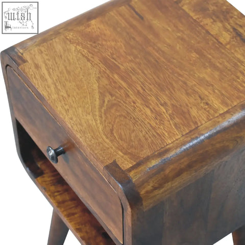 A rustic wooden mini chestnut curve lower bedside table with warm brown finish and visible grain patterns