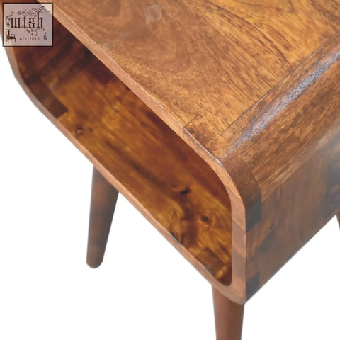 Mini chestnut curved wooden bedside table with smooth curved top tapered legs and open shelf for storage