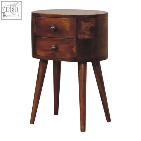A sleek mini chestnut rounded bedside table with two drawers and tapered legs in warm wooden finish