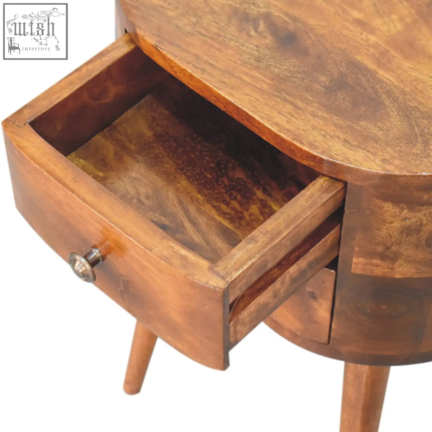 Warm-toned wooden mini chestnut rounded bedside table with curved top tapered legs and silver knob drawer