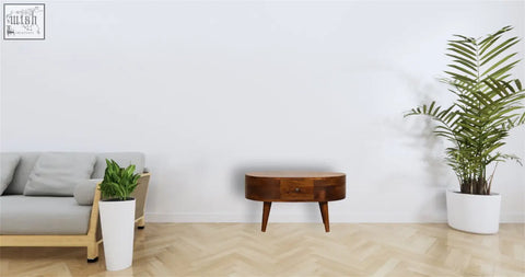 Mini chestnut rounded coffee table with sleek oval wooden top, single drawer, tapered legs, and rounded edges