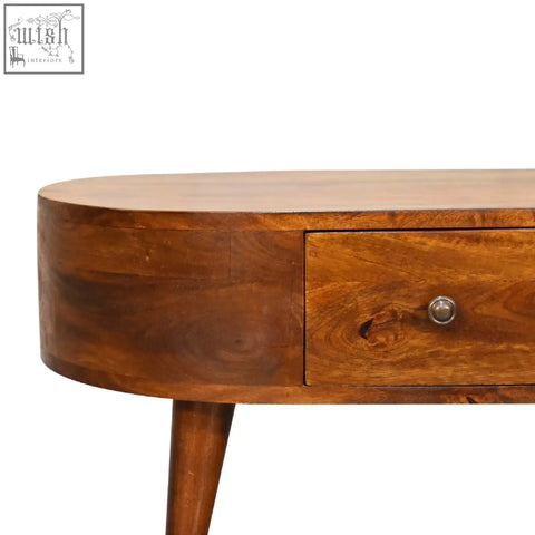 A warm medium-brown wooden mini chestnut rounded coffee table with a single drawer and rounded edges