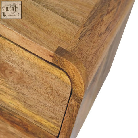 Rustic mini curve floating bedside table in warm natural solid mango wood with visible grain patterns