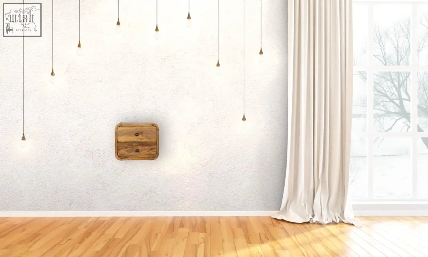 A rustic mini curve floating bedside table in solid mango wood with a natural finish and two drawers