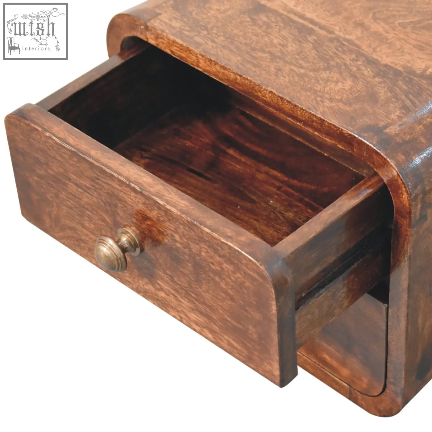 A rich dark brown mini curved california walnut wall mounted nightstand with a brass knob drawer