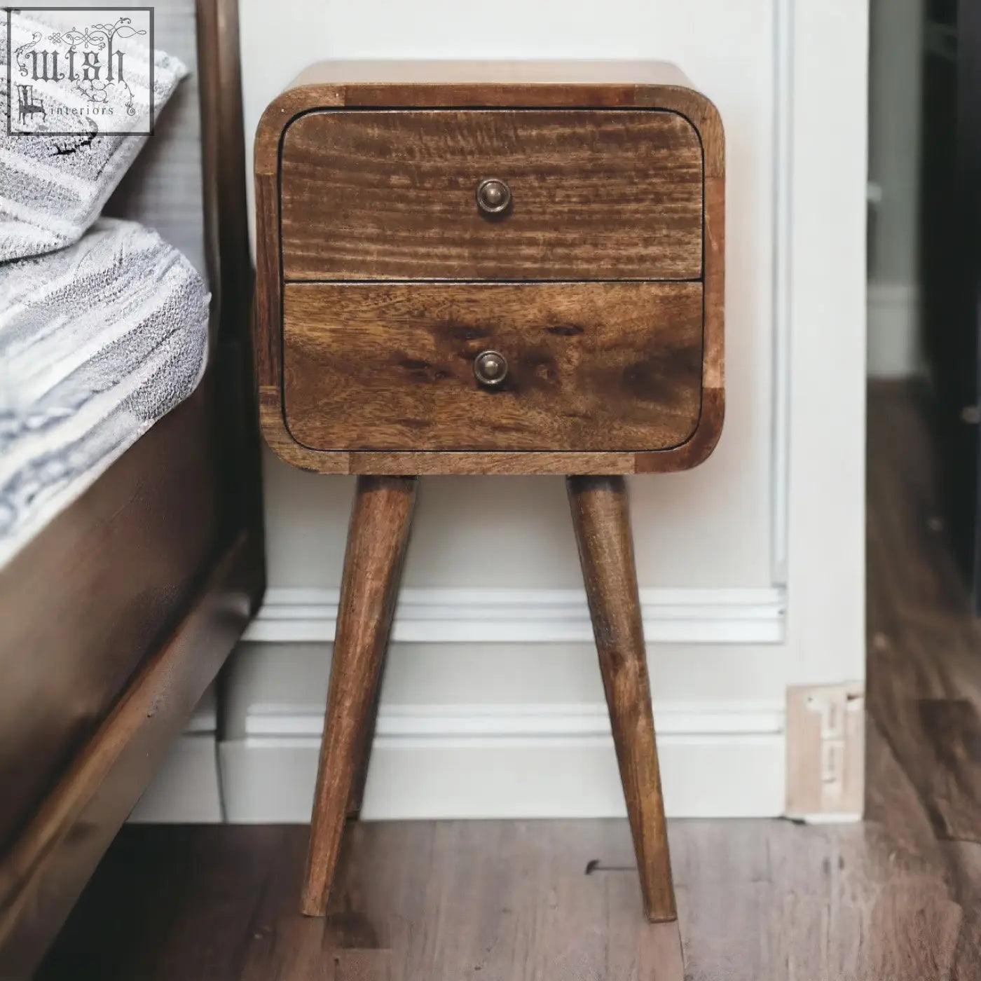 Mini curved grey washed bedside table with solid mango wood, warm brown finish, two drawers, and brass knobs