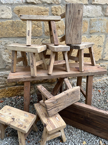 Rustic wooden mini elm stools with natural grain and weathered finish perfect for cozy seating areas
