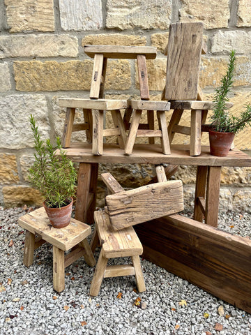 Mini elm stools made of rustic wood with weathered natural grain and varied light to medium brown tones
