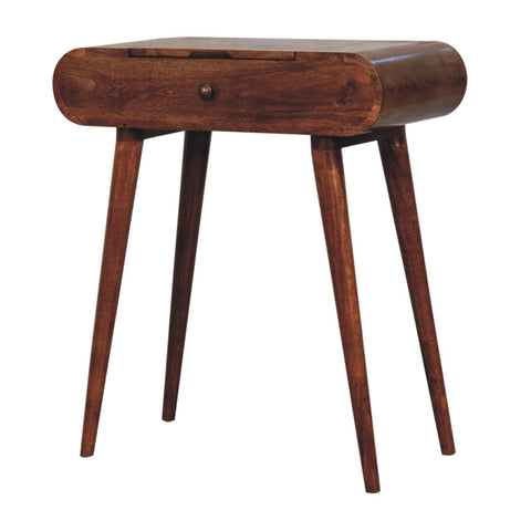 A sleek mini honey caramel wooden dressing table with a foldable mirror and curved top with tapered legs