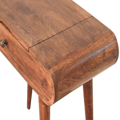 A warm brown wooden mini honey caramel side table with tapered legs small drawer and foldable mirror