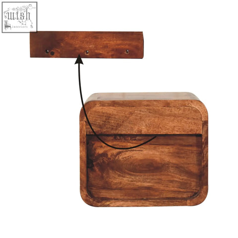 A rustic mini honey caramel wall mounted bedside with open slot made of warm brown mango wood with visible grain