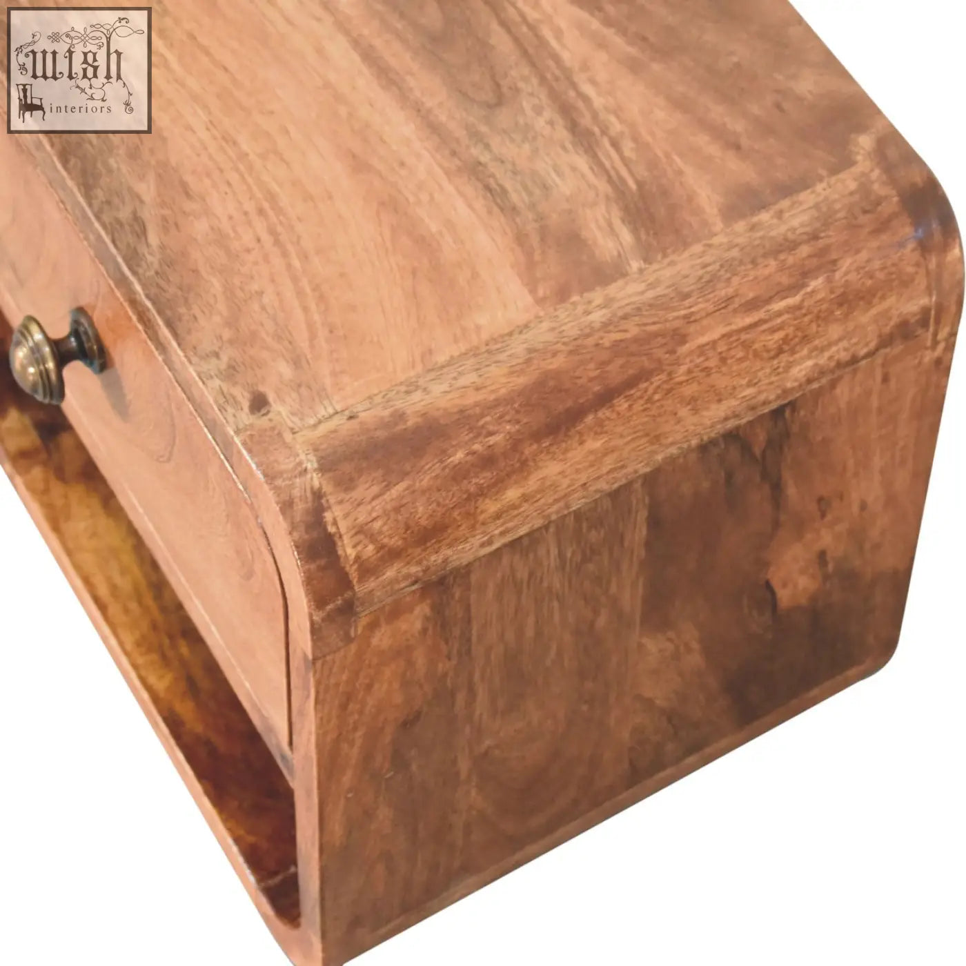 Warm-toned honey caramel mango wood nightstand with curved drawer front, dark brass knob, and open slot design