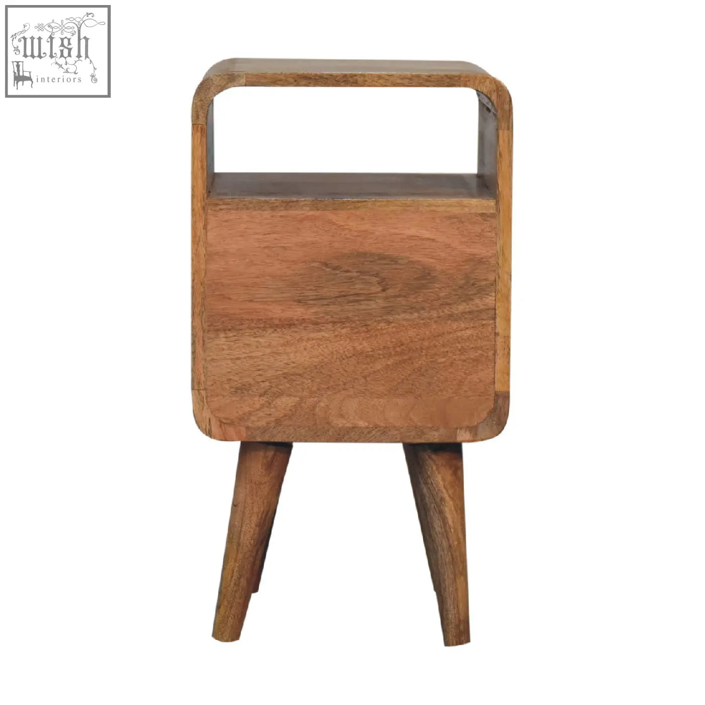 A warm-toned solid mango wood mini lille curved bedside table with tapered legs and open shelf in oak finish