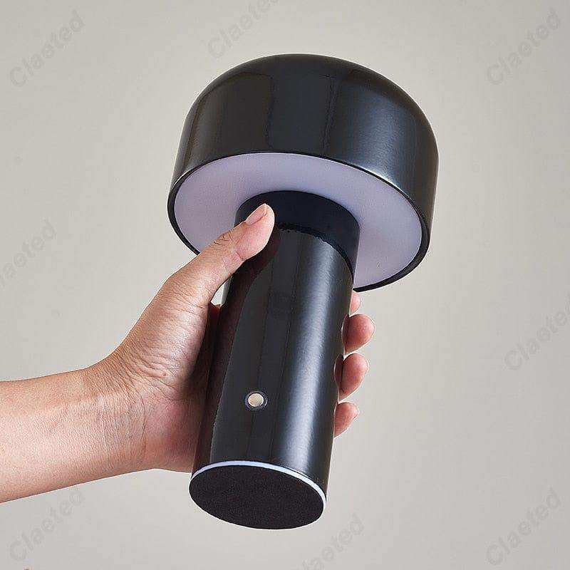 Black mini mushroom lamp with glossy finish and circular base emitting soft white light in 7 colors option
