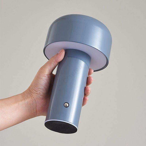 A sleek matte gray mini mushroom desk lamp with a cylindrical base and rounded top from mini mushroom lamps collection