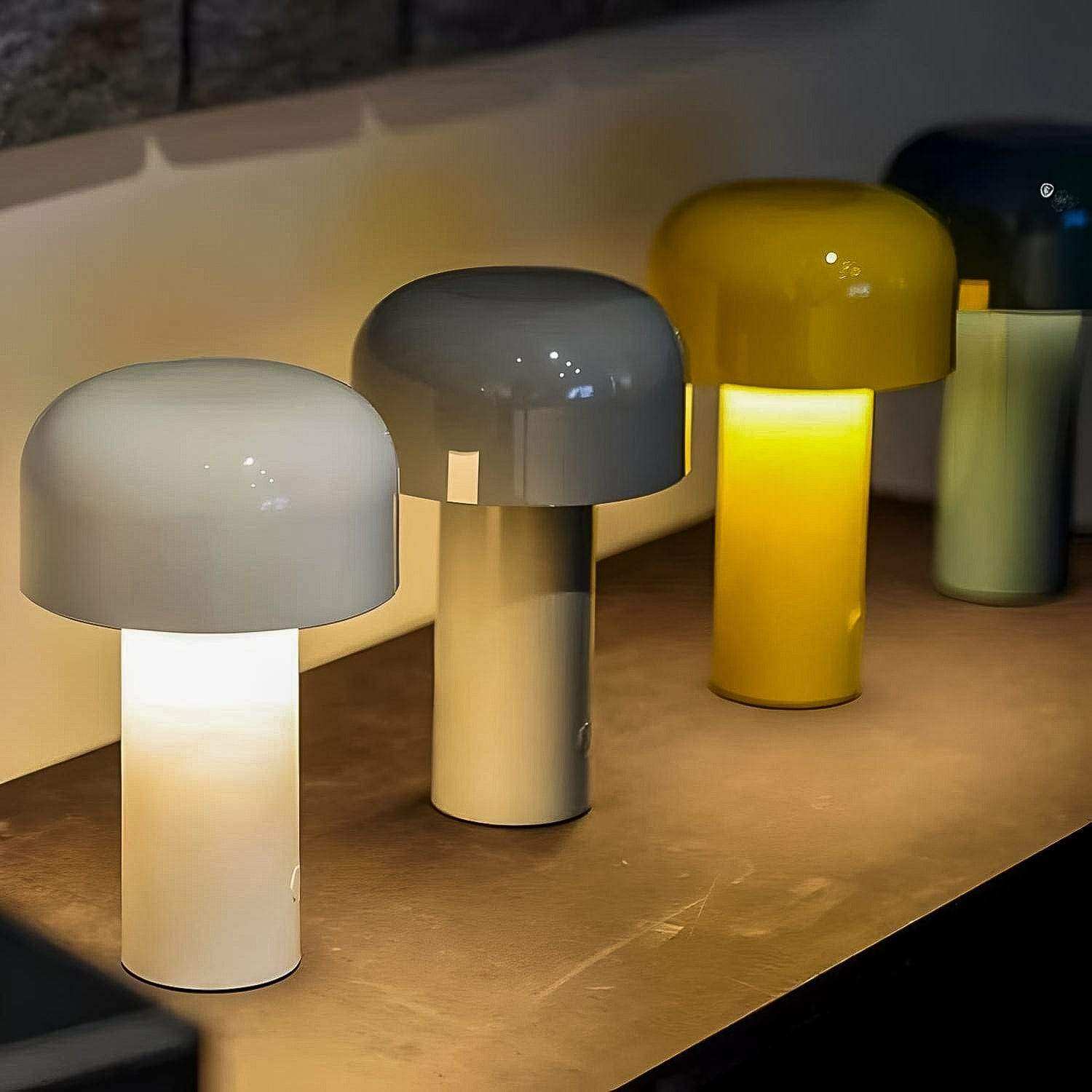 A sleek glossy white mini mushroom desk lamp with a dome shade and cylindrical base perfect for desks