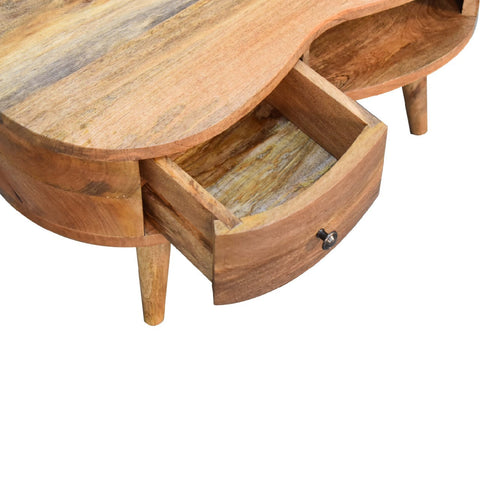 Mini oak-ish wave coffee table is a rustic light brown wooden coffee table with a curved top and an open drawer