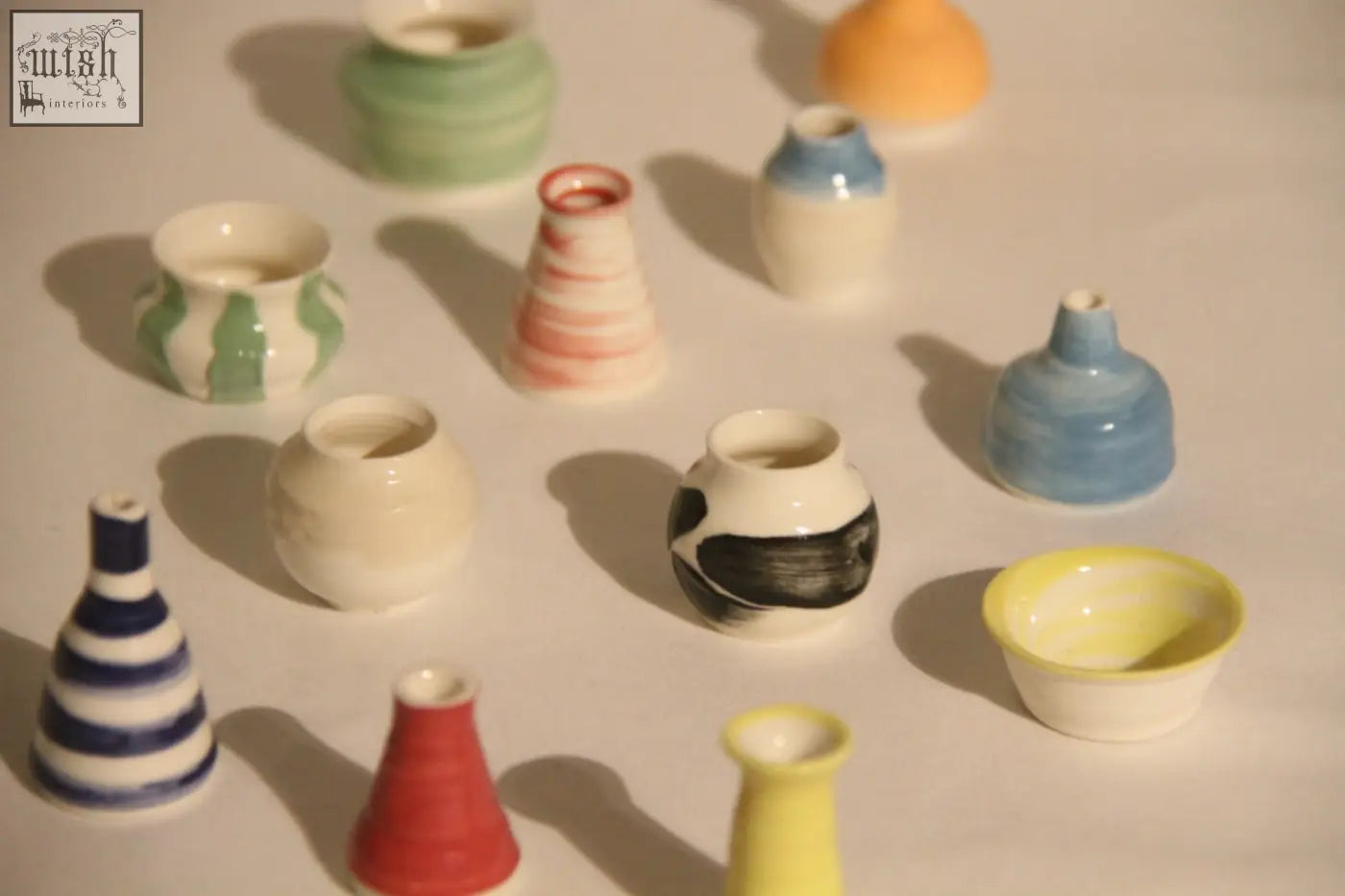 A collection of colorful hand-painted ceramic mini pots perfect for your mini pot mystery or pot mystery box setup