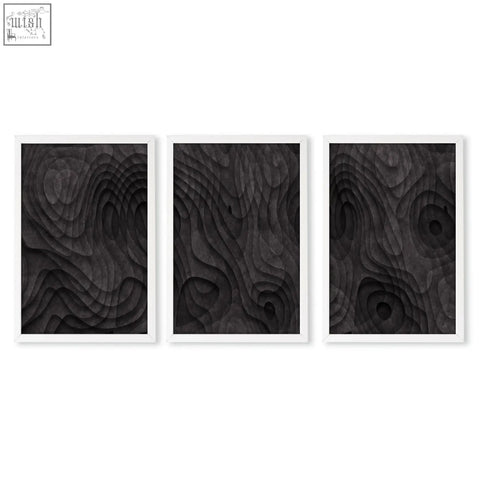 Set of three black wood relief art prints with dark charcoal minimalist topographic wave texture in white frames