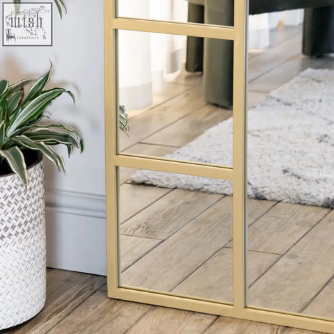 Gold metal arched full length window mirror with grid of rectangular panes measuring 180cm by 90cm