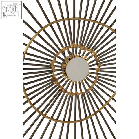 Gold-toned mirano small abstract wall art featuring a sunburst design with metal spokes and a circular mirror center