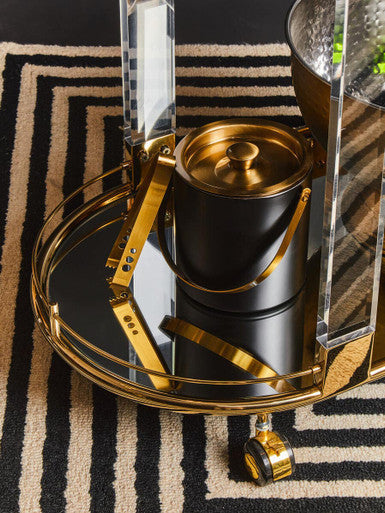 Black ice bucket with gold finish and matching lid on ornate mirrored cart perfect for gold finish ice storage