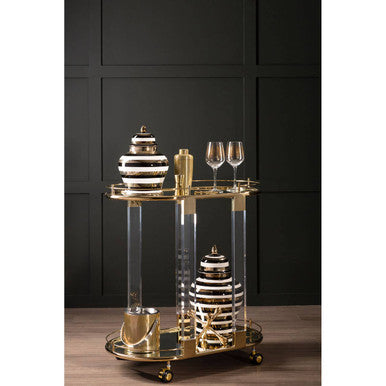 Gold-toned bar cart with transparent acrylic legs featuring a sleek modern design for mixology gold double jigger use