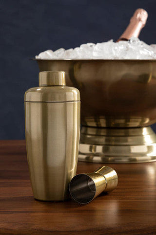 Gold-toned mixology gold double cocktail shaker and matching gold double jigger with sleek metallic finishes