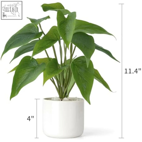 A lush artificial pothos potted plant with broad green leaves in a modern white ceramic pot for indoor decor