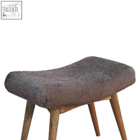 A cozy mocha faux fur curved bench with gray plush upholstery and slender wooden legs perfect for seating