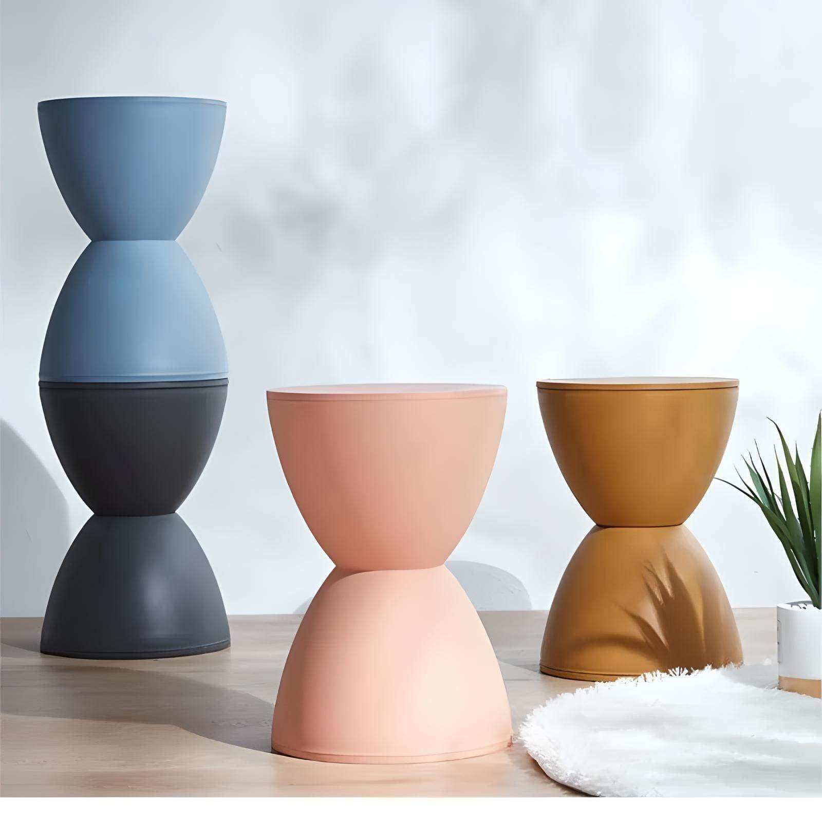 Modern minimalist moda hourglass stools in matte plastic with a sleek hourglass silhouette stacked together