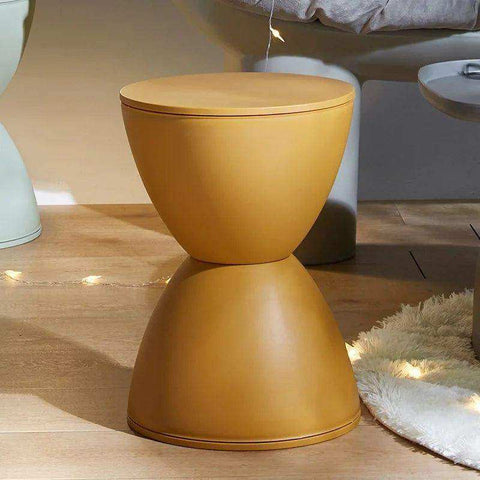 A sleek mustard-yellow two-part moda hourglass stool with smooth matte finish and rounded inverted-cone shapes